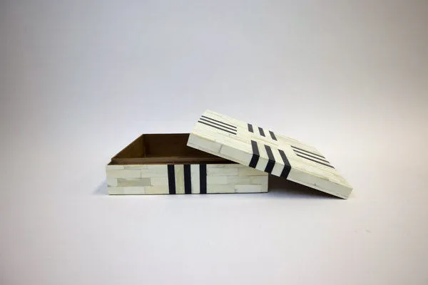 Box with lid partially open showing the interior lined in brown fabric