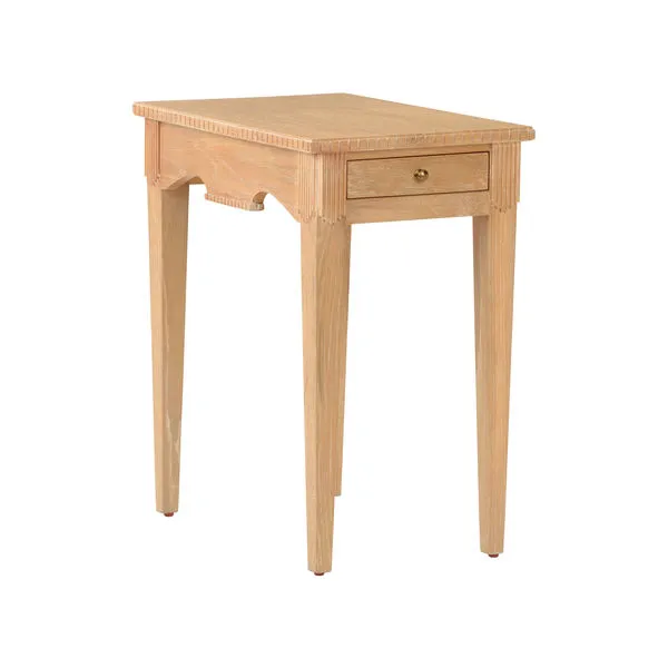 Oslo Side Table in cerused oak with tapered legs, a single drawer with brass knob, and carved edge detailing