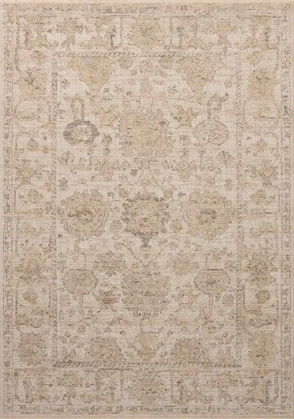 Rectangular vintage-style area rug in ivory and sand with subtle beige and grey motifs and a distressed look