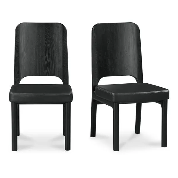 Set of two black Kerr dining chairs with high carved wood backs and padded vegan leather seats