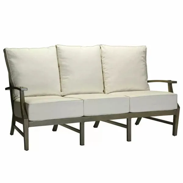 Outdoor aluminum sofa with cream cushions and sturdy frame featuring clean lines and gently flared arms