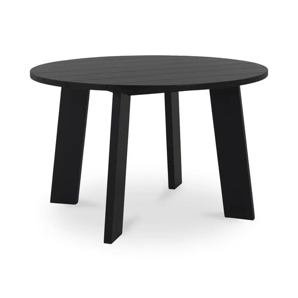 Round outdoor dining table with solid black top and angular black legs in a minimalist contemporary style
