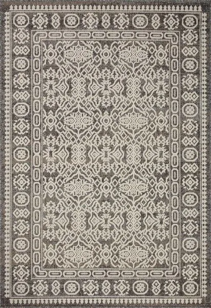 Ivory indoor/outdoor rug with intricate geometric and floral patterns in neutral tones, framed by decorative border