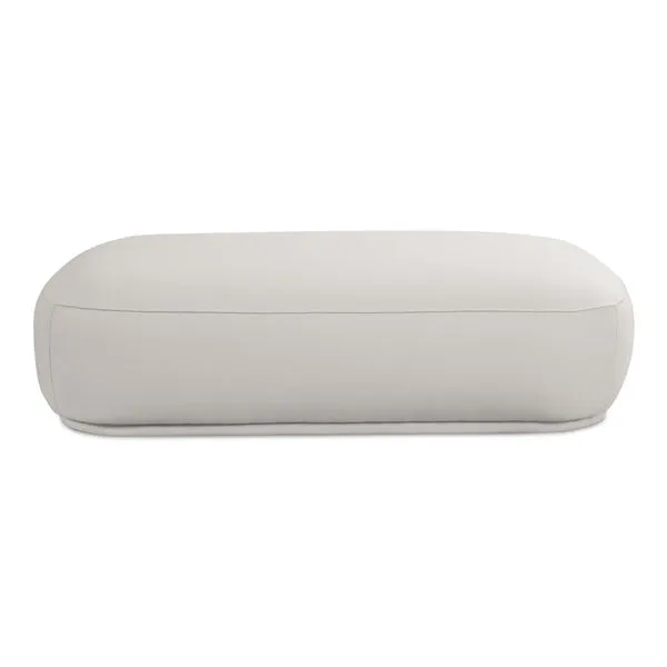 Marion Rectangular Ottoman in light beige fabric with plump curved form and recessed base for floating look
