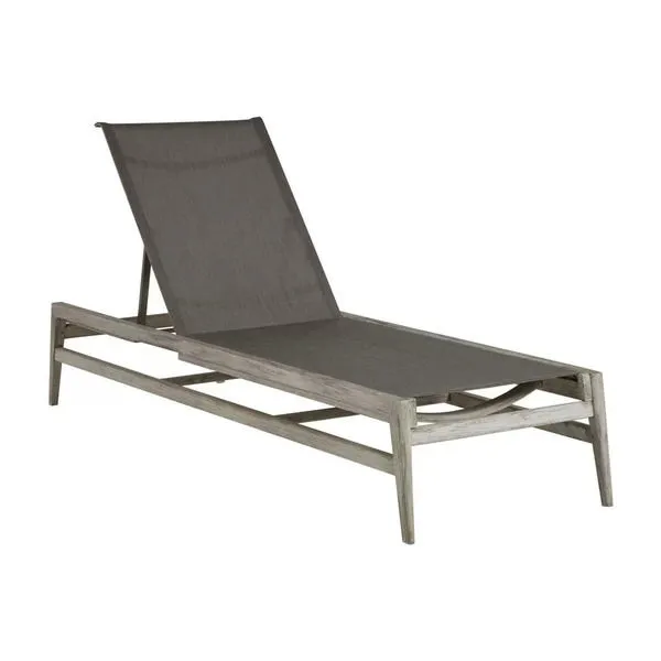 Coast Teak Chaise with gray fabric sling seating and weathered teak wood frame in a reclined position