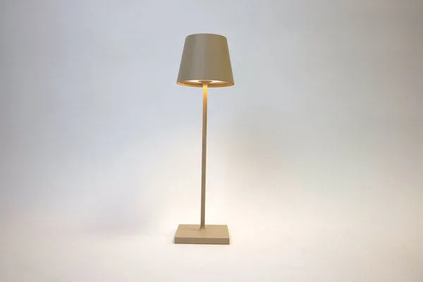 Vera Sand Poldina Mini Table Lamp turned on showing warm light beneath the shade
