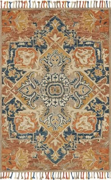 Zharah Zr 10 rug in rust and blue with intricate central medallion and floral motifs on 100% wool pile with fringed edges.