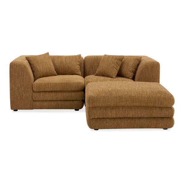 Lowtide nook modular sectional in textured brown fabric with layered cushions and vintage 1970s-inspired design