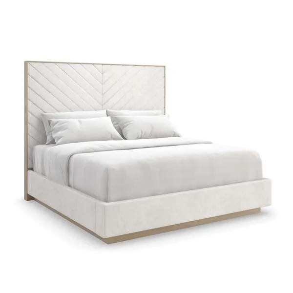 Modern bed with tall chevron-patterned padded headboard and low-profile upholstered base in a light beige fabric