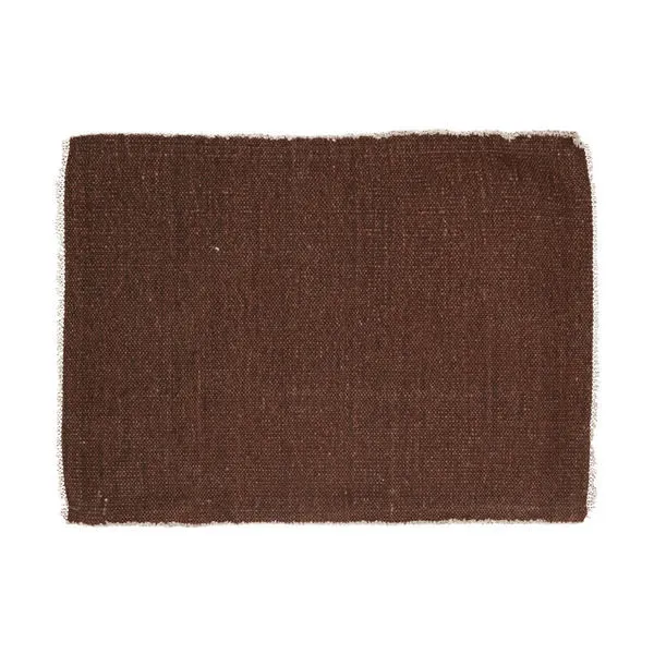 Rectangular woven placemat in rust color with subtle texture and frayed edges