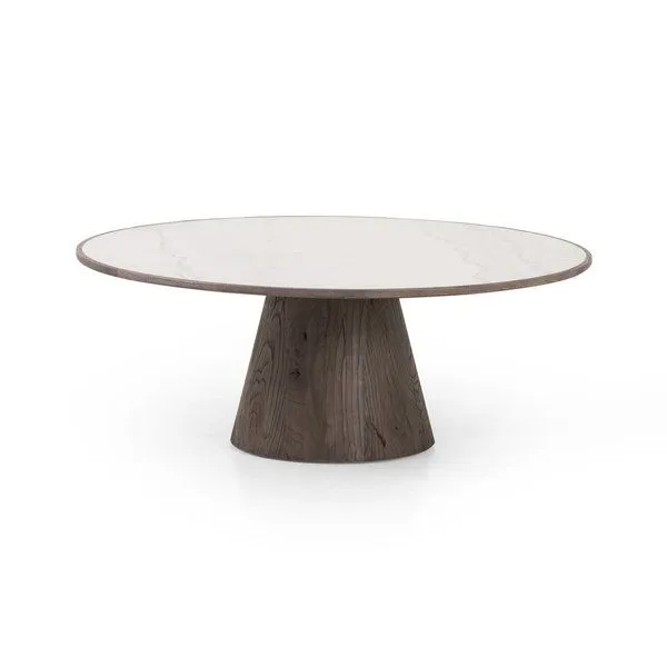 Round white marble coffee table with dark weathered oak cone-tapered base and oak edge banding