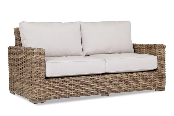 Havana Loveseat in weathered tobacco resin wicker with plush off-white cushions and a sturdy square frame