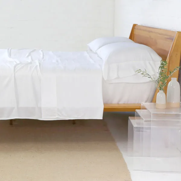 King Bamboo White Sheet Set on a wooden bed frame with crisp, silky-smooth white sheets and two pillowcases