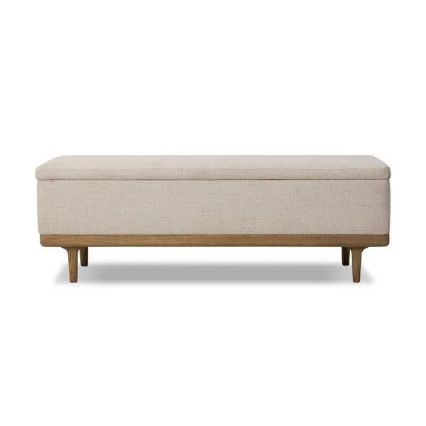 Spacious rectangular trunk with cream textured fabric upholstery and worn oak frame and tapered legs