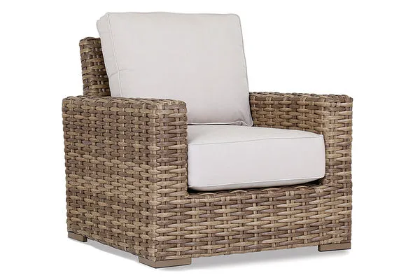 Havana Club Chair with ample proportions, premium all-weather wicker in rich Aged Tobacco, beige seat and back cushions