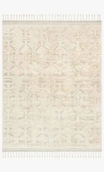 Soft shaggy wool rug in neutral oatmeal and ivory with subtle Scandinavian-inspired geometric motifs and fringed edges