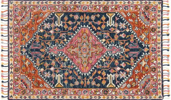 Navy and white wool rug with bold central medallion and intricate floral border with tassels