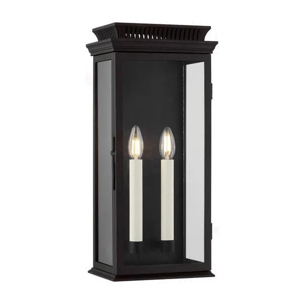 Louie Exterior Wall Sconce in Forged Iron finish with three glass panels and two off-white candlestick lights