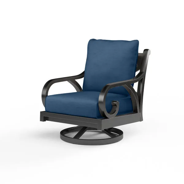 Outdoor swivel rocker chair with curled espresso-finished aluminum arms and navy blue cushions