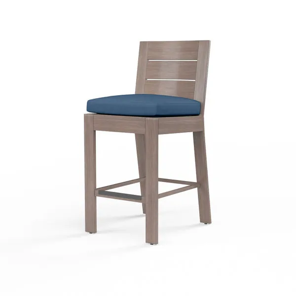 Laguna Barstool in driftwood finish aluminum with slatted back and navy blue cushion