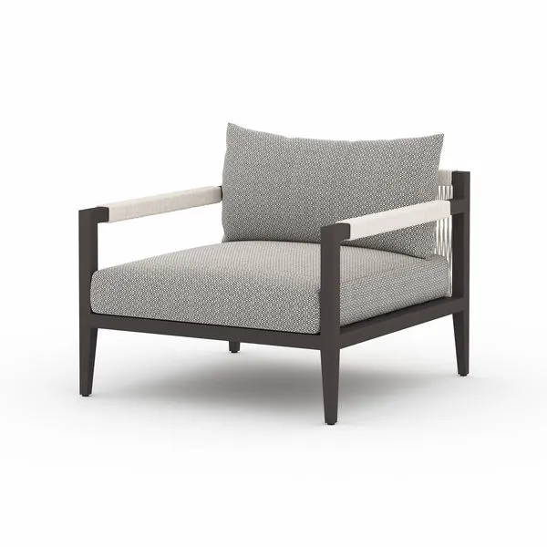 Sherwood Outdoor Faye Ash Bronze Chair with dark aluminum frame, gray patterned cushions, and rope-wrapped armrests