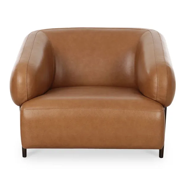 Devlin lounge chair with oversized tan top-grain leather seat and rounded arms on dark solid ash legs