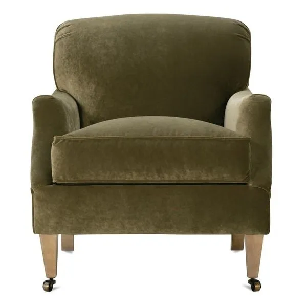 Marleigh accent chair with olive velvet upholstery, cushioned seat, rolled arms, and wooden legs with front casters