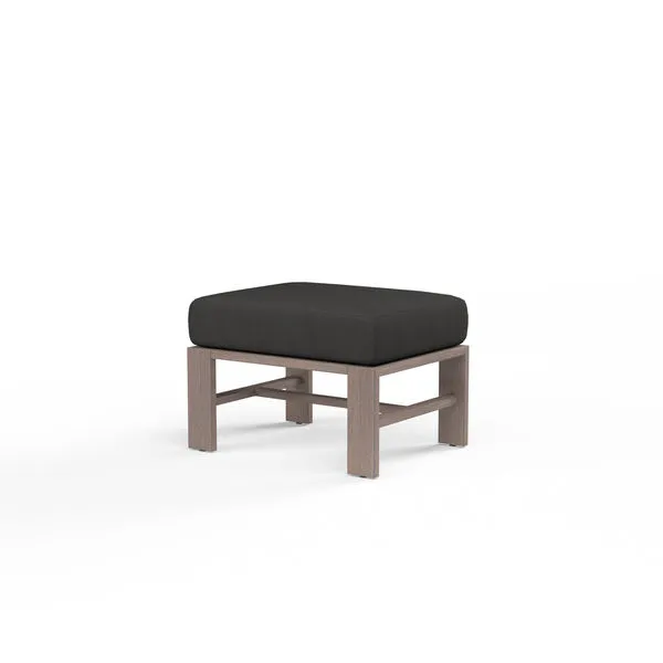 Laguna Ottoman with driftwood-look aluminum frame and dark cushion in a modern square design