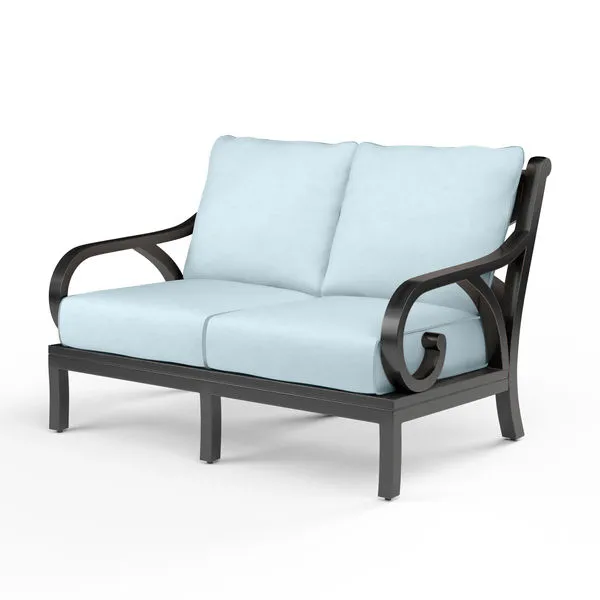 Monterey Loveseat with dark espresso aluminum frame, curved armrests, and light blue cushions