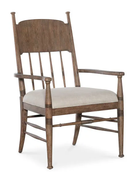 Americana Upholstered Seat Arm Chair with spindle back, carved accents, oak veneer frame, honey brown finish, and beige fa...