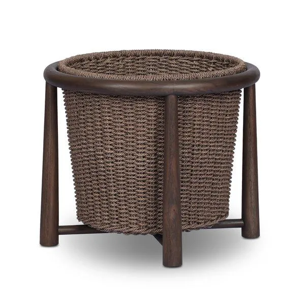 Kernan Basket with woven brown basket nested in a solid teak round frame with tapered legs