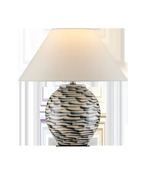 Minnows Blue Table Lamp with a beige ceramic base decorated in blue fish-like brush strokes and a flared empire white shade