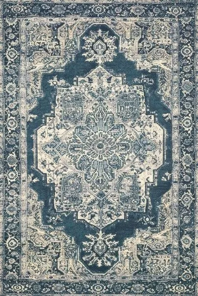Dark blue and beige tribal-inspired power-loomed rug with central medallion and intricate border