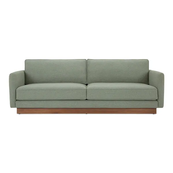 Vernon sofa in sage green fabric with wooden plinth base and removable cushions, mid-century modern style