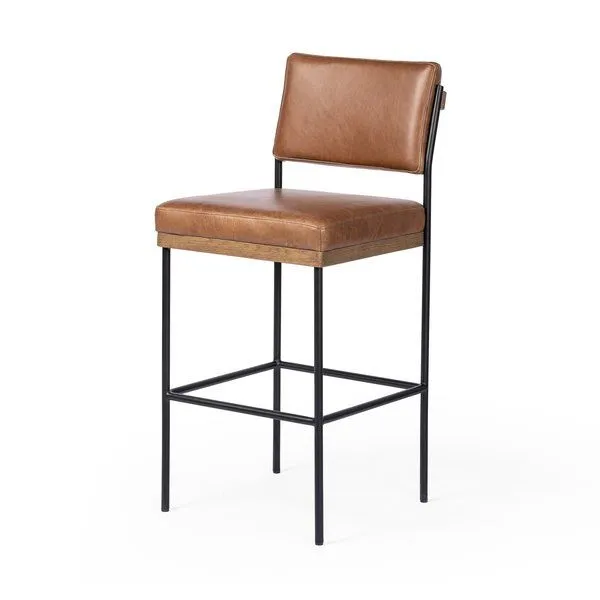 Benton Stool angled to show square footrest and side profile of leather seat cushioning