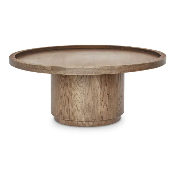 Cohen coffee table in solid oak with tray-style round top and cylindrical pedestal base in rich brown finish