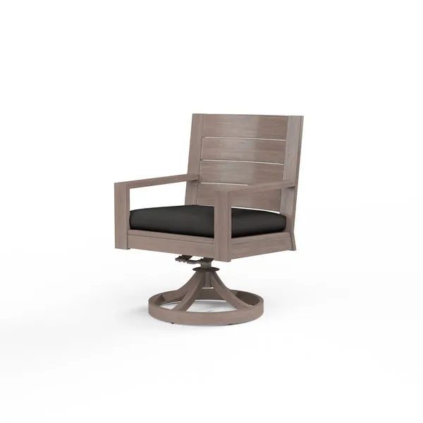 Laguna Swivel Dining Chair in hand-brushed aluminum finish mimicking driftwood with black cushion on round swivel base