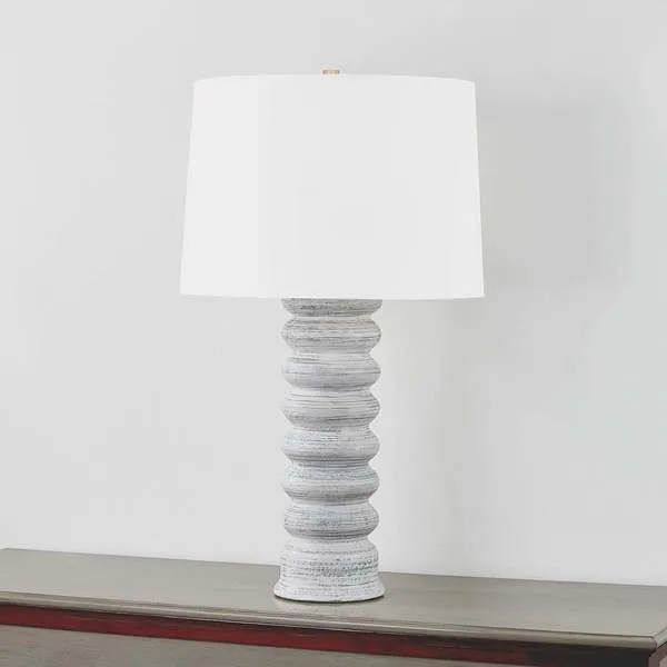 Harwinton Table Lamp lit with a slightly angled view against a plain wall