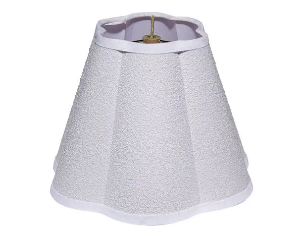Tapered lamp shade with softly scalloped edges, natural raffia texture, and linen trim with brass harp