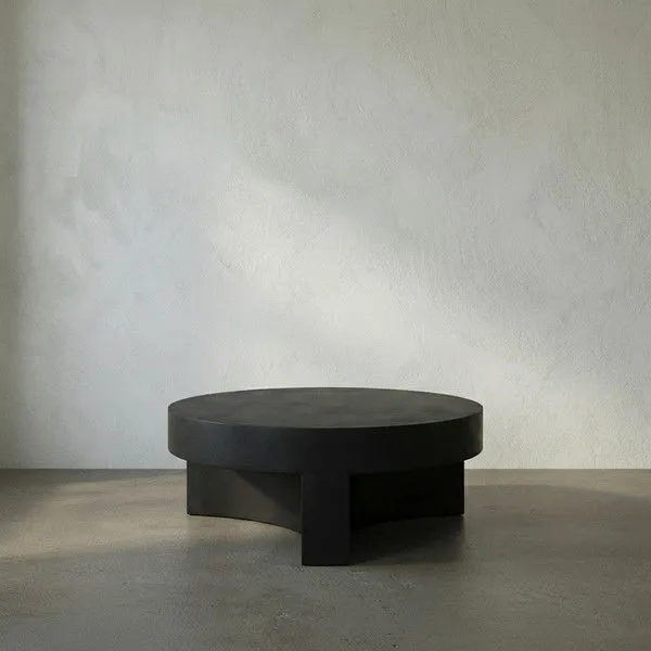 Steward Coffee Table in matte black industrial steel with circular top and curved, solid base