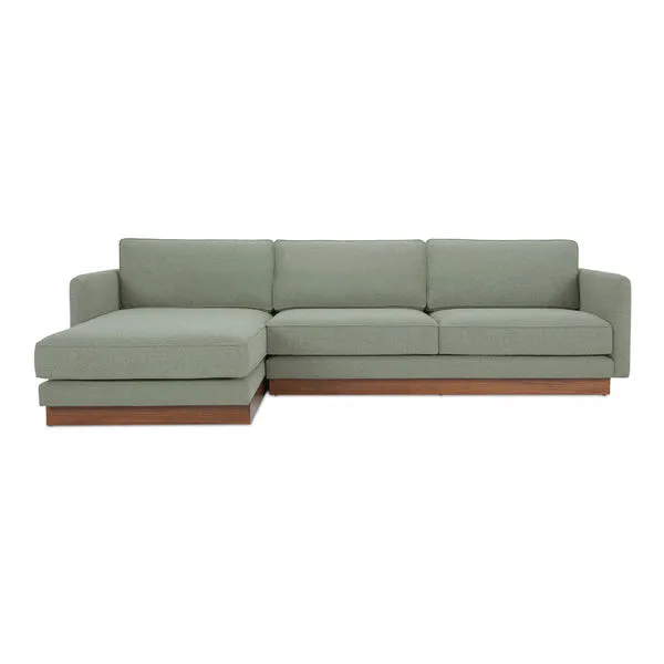 Mid-century style Vernon sectional sofa with sage green fabric and wooden plinth base, left chaise configuration