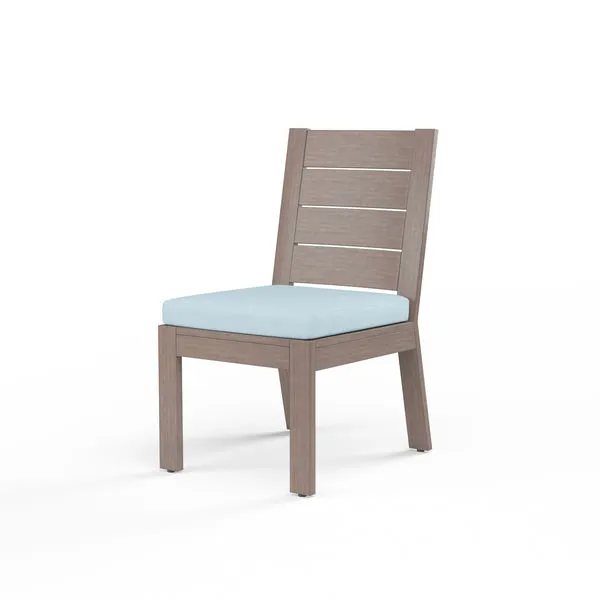 Laguna Armless Dining Chair with driftwood-look aluminum frame and light blue seat cushion