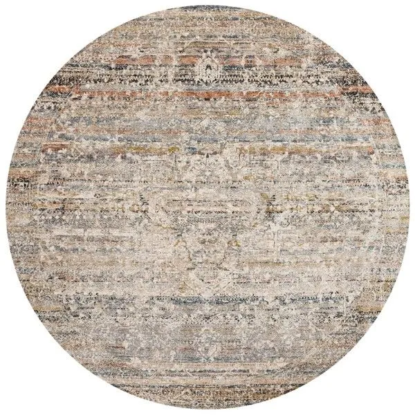 Round rug with a muted taupe and multi-color pattern featuring subtle pile height variation and fringe edges