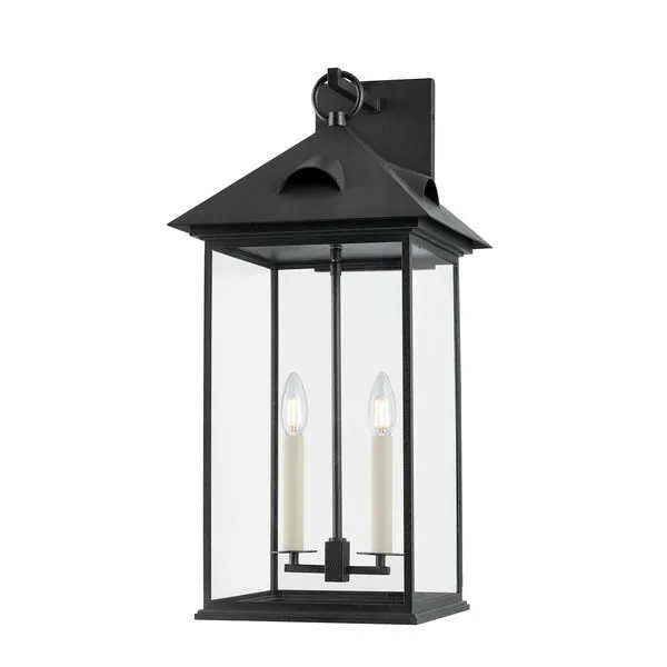 Corning Exterior Wall Sconce in forged iron with four clear glass panels and two candle-style bulbs