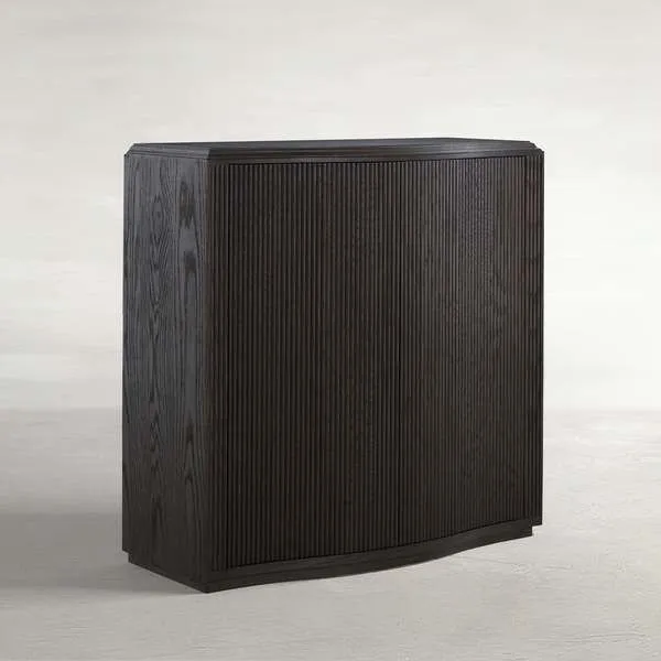Compact Theodore Short Console table with ribbed oak veneer and wave-front silhouette in dark finish.