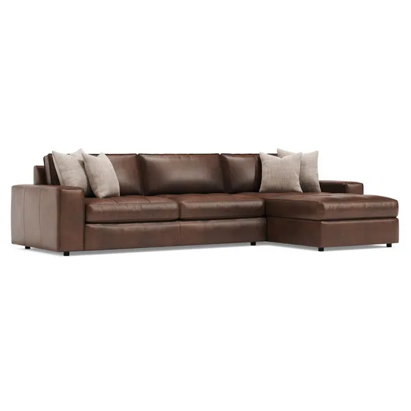Nest 2-piece leather sectional in rich brown with wide track arms and beige accent pillows
