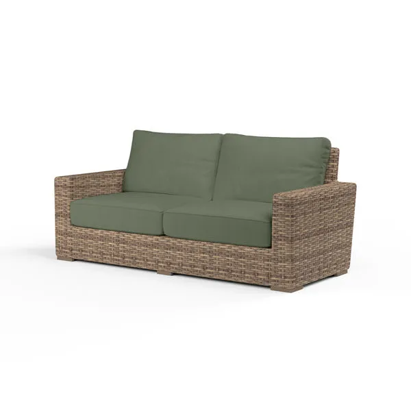 Havana Loveseat with aged tobacco all-weather wicker and sage green cushions, spacious and durable outdoor seating