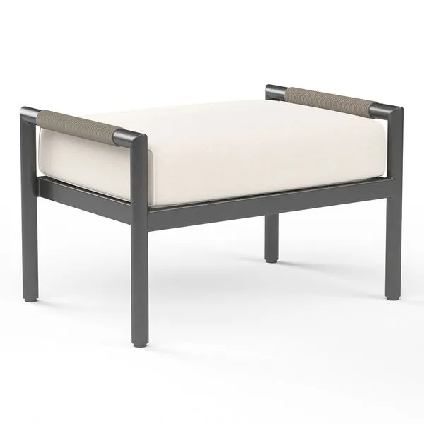 Pietra Ottoman in matte graphite aluminum frame with rounded tube legs and off-white cushioned top