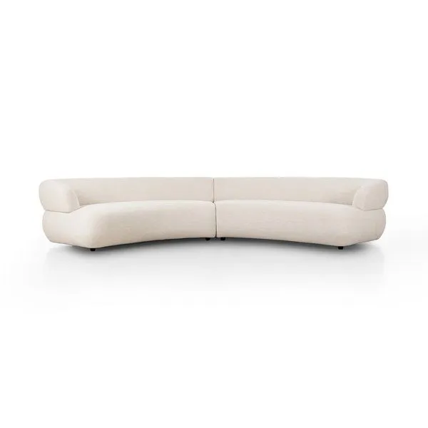 Large curved sectional sofa in light beige high-performance fabric with smooth continuous back and wide rounded armrests