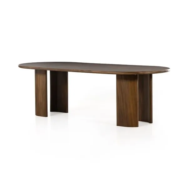 Oval dining table in caramel guanacaste wood with arched legs and smooth rounded edges